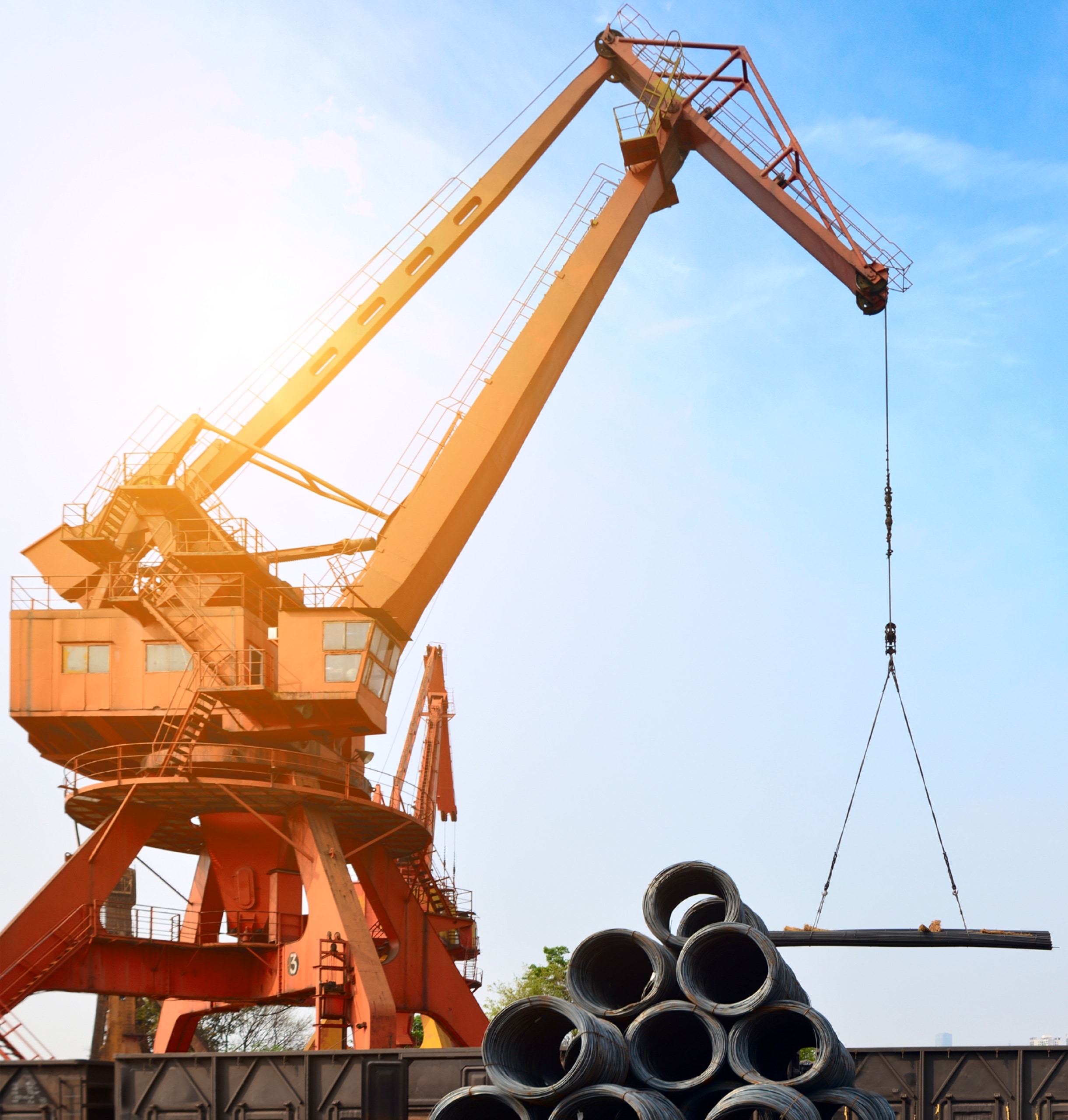 Construction crane lifting materials at a port